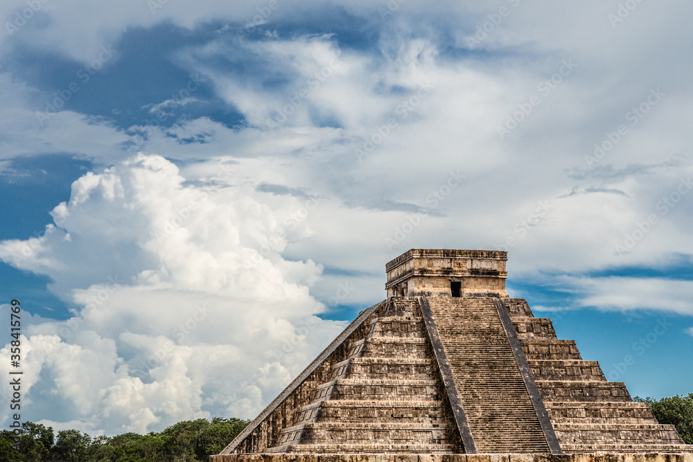 Low angle view of ancient pyramid of Kukulkan against cloudy sky