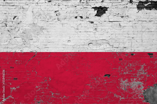 Poland flag on grunge scratched concrete surface. National vintage background. Retro wall concept.