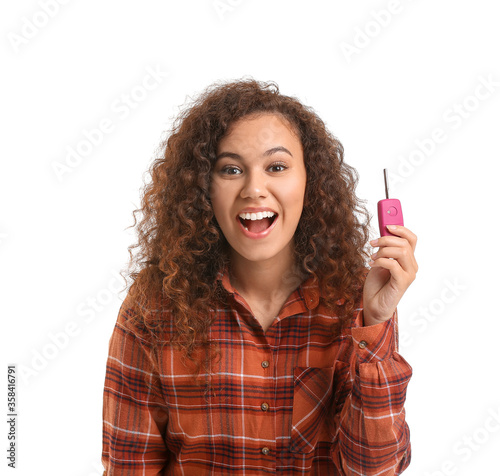 Young woman with car key on...