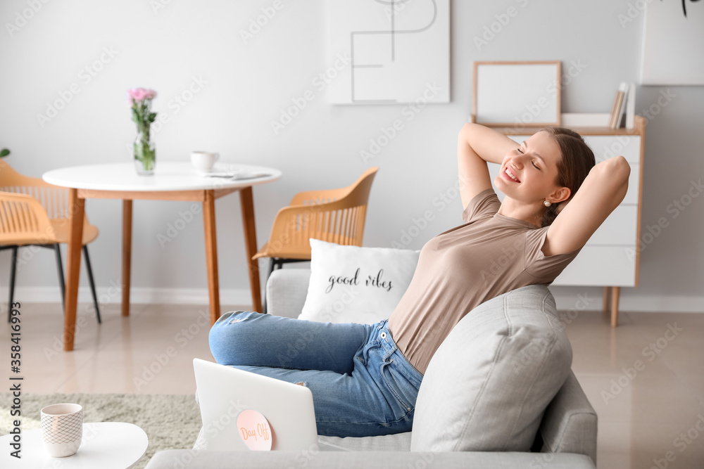 Businesswoman relaxing on sofa before weekends at home Businesswoman relaxing on sofa before weekends at home