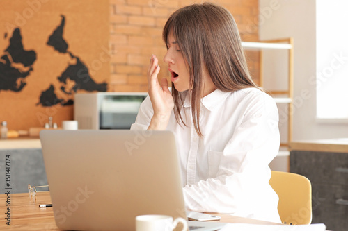 Tired woman working at home...