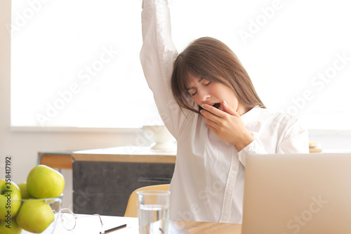 Tired woman working at home...