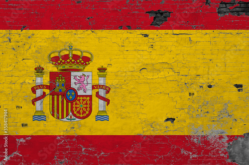 Spain flag on grunge scratched concrete surface. National vintage background. Retro wall concept.