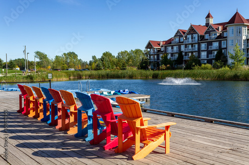 Colorful Muskoka chairs on Mill pond dock during fall at Blue Mountains Village photo