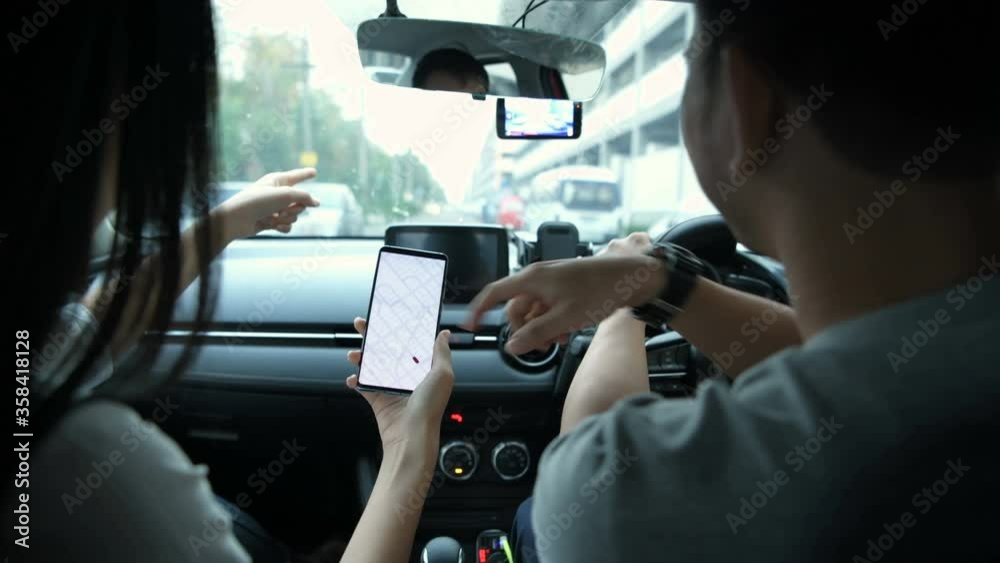 Navigation concept. Couple asian using smartphone with map in car. 4k Resolution. Navigation concept. Couple asian using smartphone with map in car. 4k Resolution.