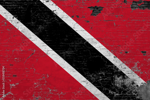 Trinidad And Tobago flag on grunge scratched concrete surface. National vintage background. Retro wall concept.