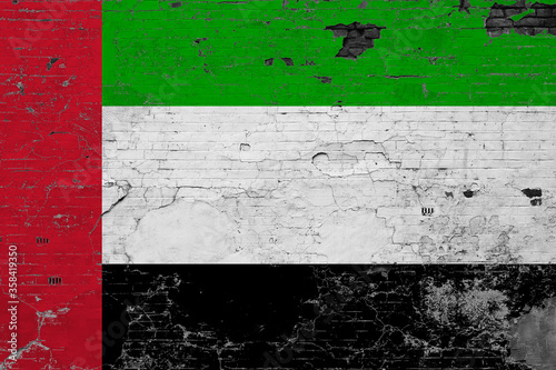 United Arab Emirates flag on grunge scratched concrete surface. National vintage background. Retro wall concept. © sezerozger