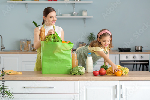 Mother and daughter unpacki...