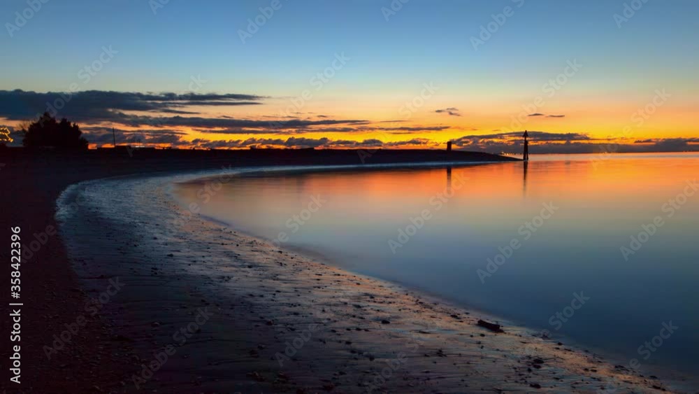 Lockdown time lapse shot of shore against orange and blue sky at sunset - Crescent Beach, Canada Lockdown time lapse shot of shore against orange and blue sky at sunset - Crescent Beach, Canada