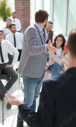 group of employees discussing something at a business meeting