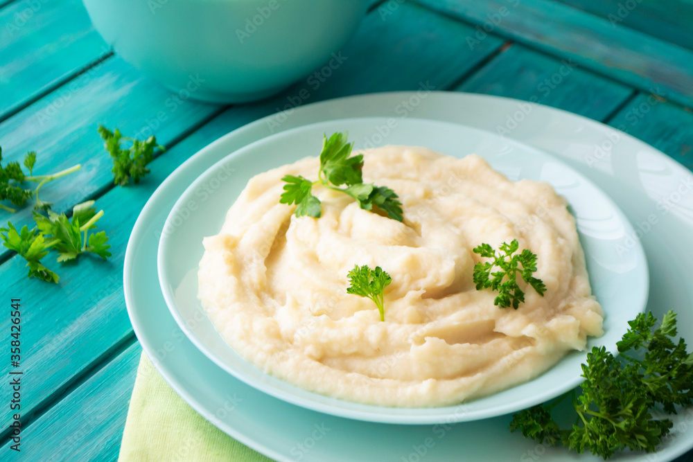 Mashed pureed potato in bowl on wooden table Mashed pureed potato in bowl on wooden table