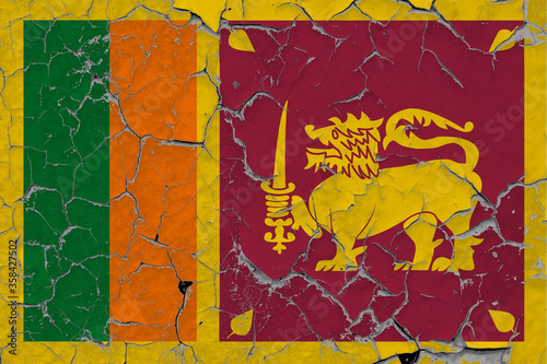 Sri Lanka flag close up grungy, damaged and scratched on wall peeling off paint to see inside surface. Vintage National Concept.