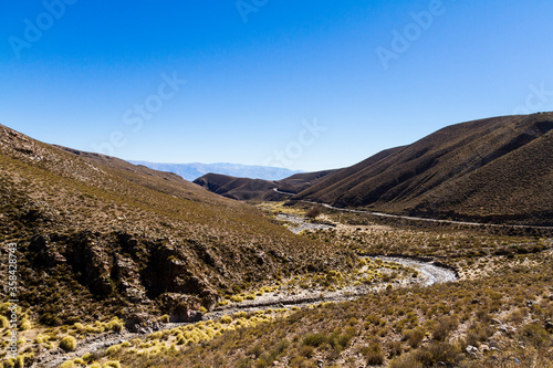 River flowing down from the mountains and eroded mountains forming broad valleys