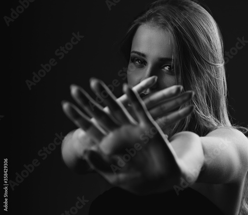Obraz na plátne Angry young female blond model showing the hands and  signaling to stop against  fight and useful violence