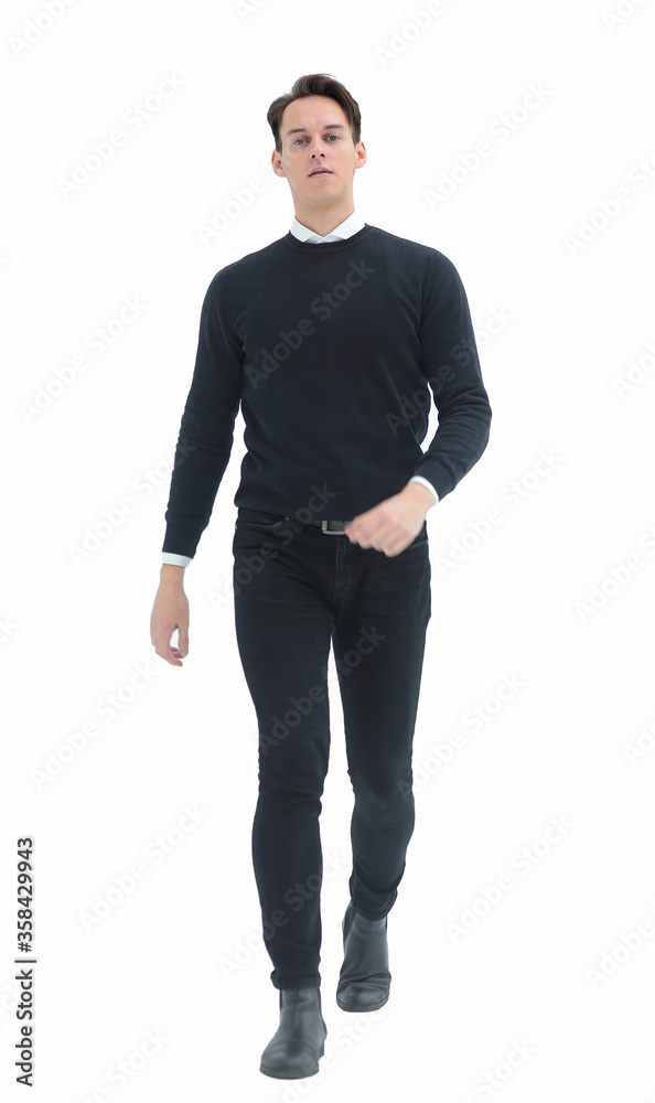 in full growth. confident th young man striding forward. in full growth. confident th young man striding forward.