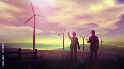 Silhouettes of engineers watching wind farms at sunset.