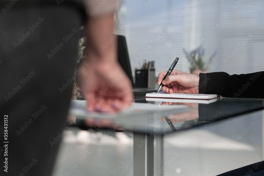 Businessman writes with a pen in diary in a sunny office, busine Businessman writes with a pen in diary in a sunny office, busine