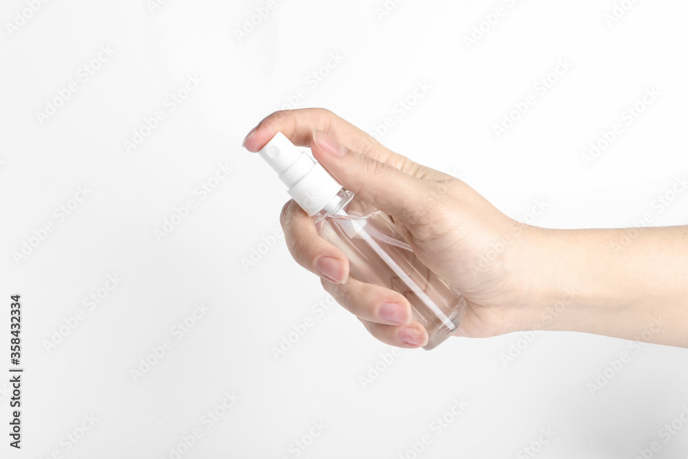 Woman holding antiseptic spray on white background, closeup Woman holding antiseptic spray on white background, closeup