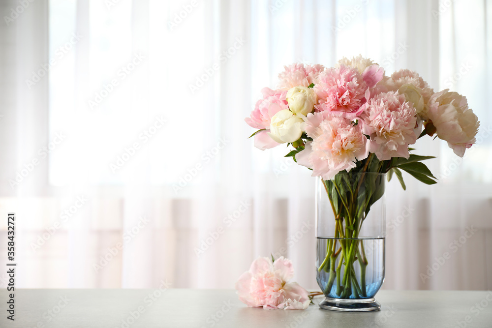 Beautiful peony bouquet in vase on table indoors. Space for text Beautiful peony bouquet in vase on table indoors. Space for text