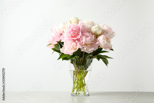 Fototapeta Naklejka Na Ścianę i Meble -  Beautiful peony bouquet in vase on table against white background