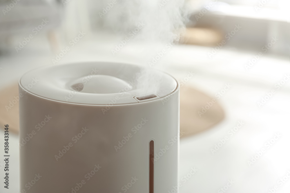 Modern humidifier indoors, closeup view. Home appliance Modern humidifier indoors, closeup view. Home appliance