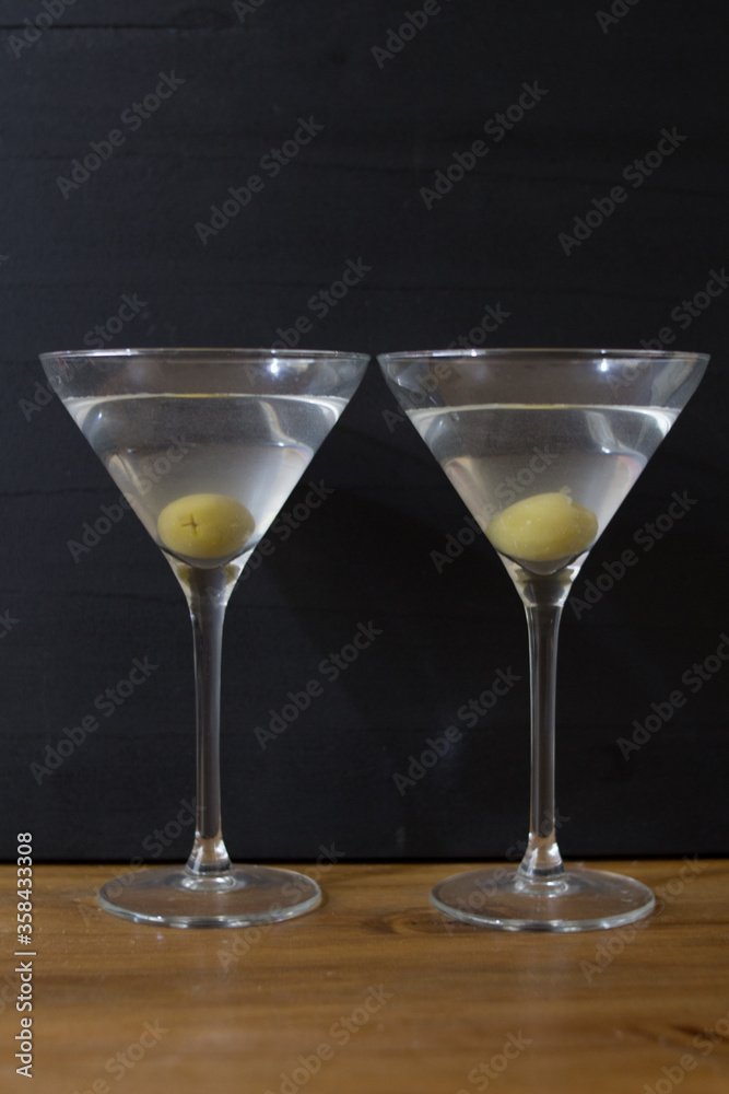 Martini glasses and on wooden table Martini glasses and on wooden table