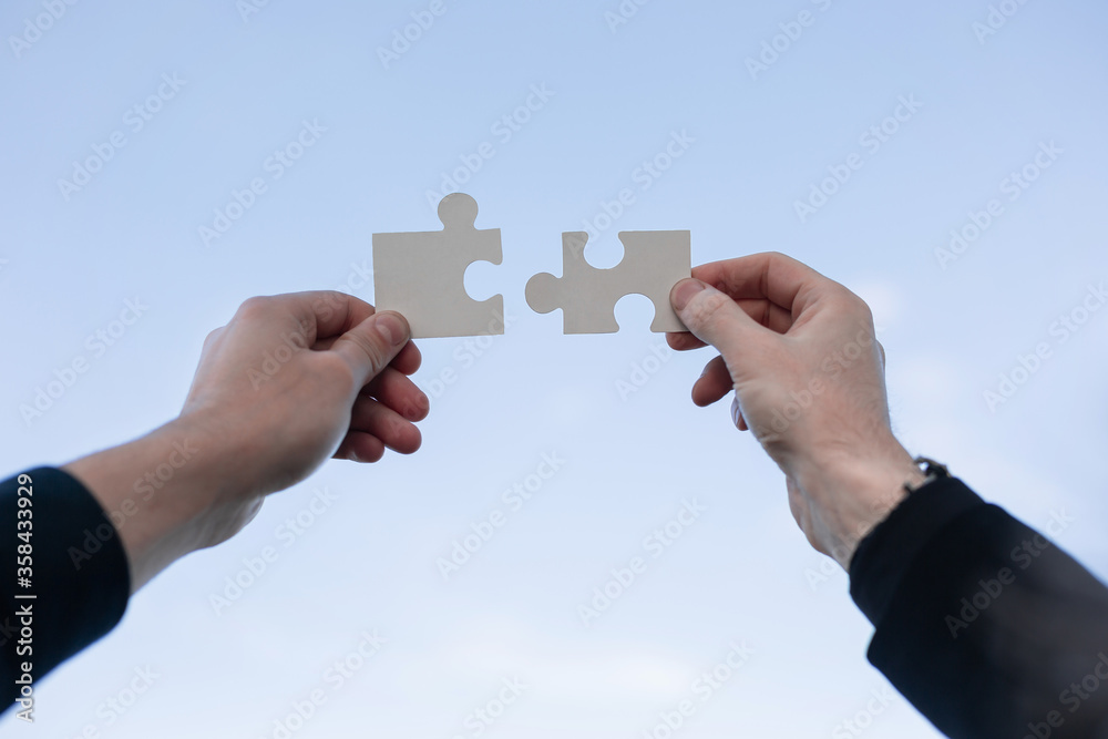 two 2 hands trying to connect couple puzzle piece two 2 hands trying to connect couple puzzle piece