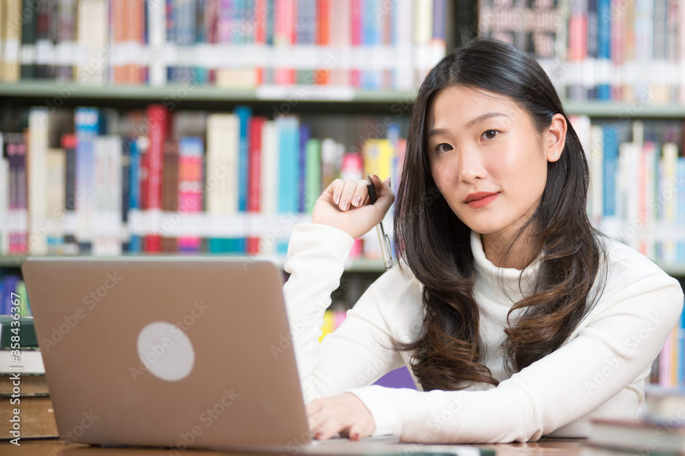 Asian women use laptops for presentations. Her face is all smiling. Asian women use laptops for presentations. Her face is all smiling.