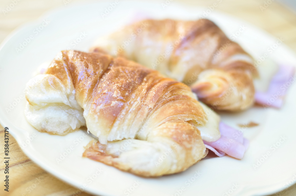 Fresh croissants with ham and cheese on plate Fresh croissants with ham and cheese on plate