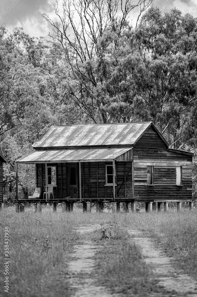 Disused wooden homestead surrounded by grazing field and dramatic stormy sky in Kroombit Tops National Park, Queensland Disused wooden homestead surrounded by grazing field and dramatic stormy sky in Kroombit Tops National Park, Queensland