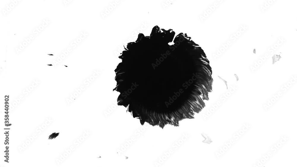 Black ink drop dripping and spreading on white paper, ink motion effect, liquid
