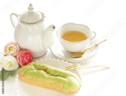 Green tea eclair puff cream confectionery on white dish with copy space