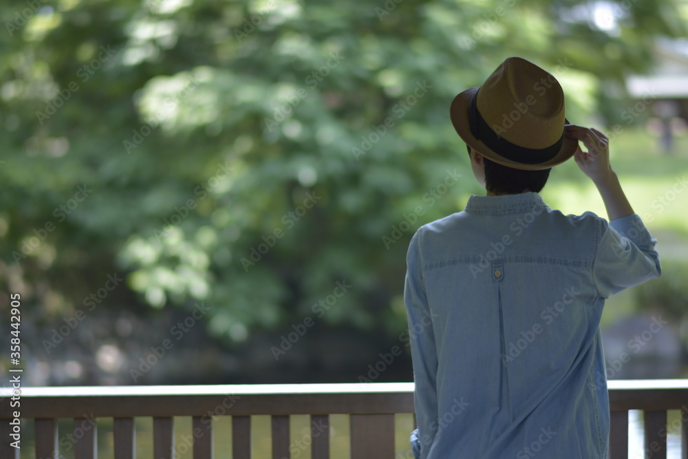 Asian young women. like spending time in the middle of nature. wear a hat at a rakish angle. blurred background with copy space. Asian young women. like spending time in the middle of nature. wear a hat at a rakish angle. blurred background with copy space.