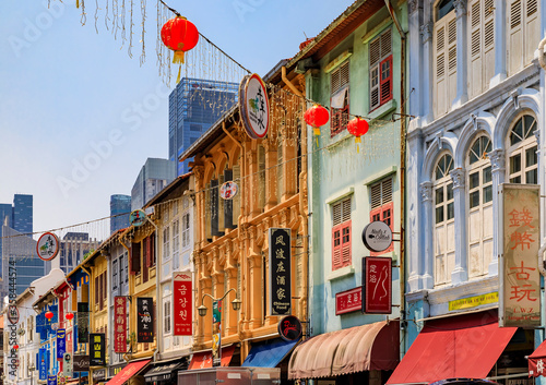 Facades of famous colorful colonial shop houses decorated with Chinese lanterns and fairy lights in Singapore Chinatown photo