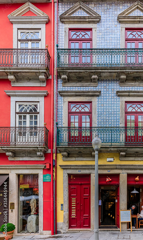 Facades of traditional houses decorated with ornate Portuguese azulejo tiles in Porto, Portugal