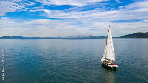 Small sailing boat in vast seascape between Bird Island and Turkey Beach, Queensland