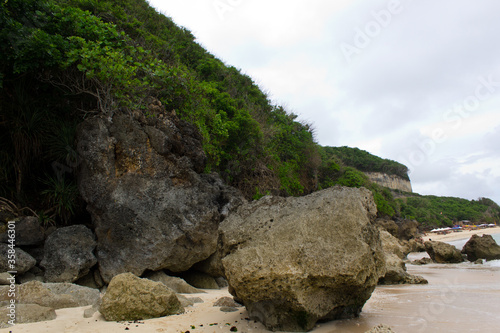 coral rocks and green hills in the beach area