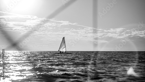 Small sailing boat in vast seascape between Bird Island and Turkey Beach, Queensland photo