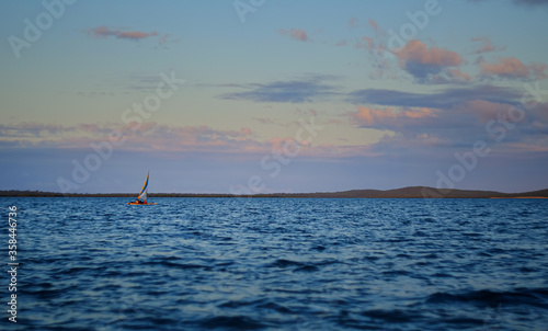 Small sailing boat in vast seascape between Bird Island and Turkey Beach, Queensland
