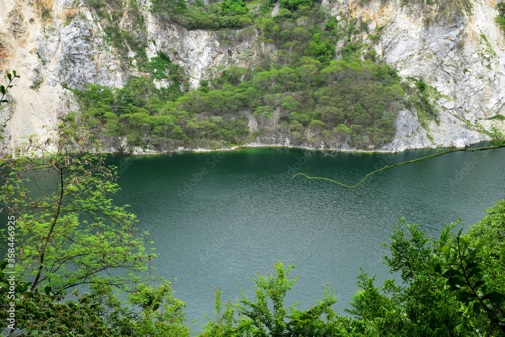 Lake reflection with green nature in the old mine Thailand