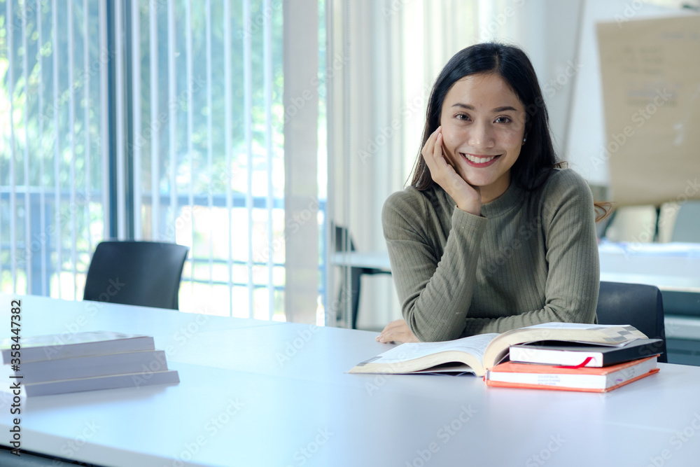 Students read books in the classroom. Asian student in uniform reading book in classroom at university Students read books in the classroom. Asian student in uniform reading book in classroom at university