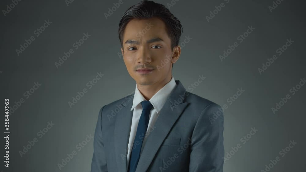 Young Asian businessman wearing a grey suit - portrait of success Young Asian businessman wearing a grey suit - portrait of success