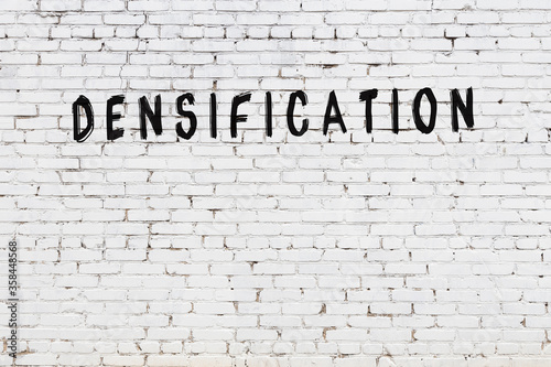 Photos White wall with black paint inscription densification on it