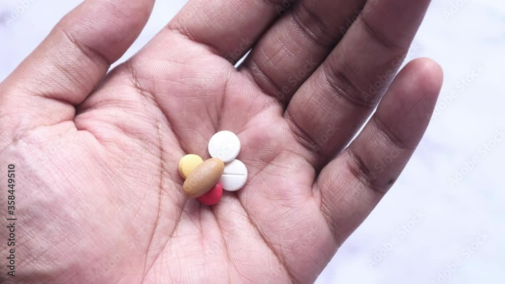 close up of pills and capsule on palm of hand close up of pills and capsule on palm of hand