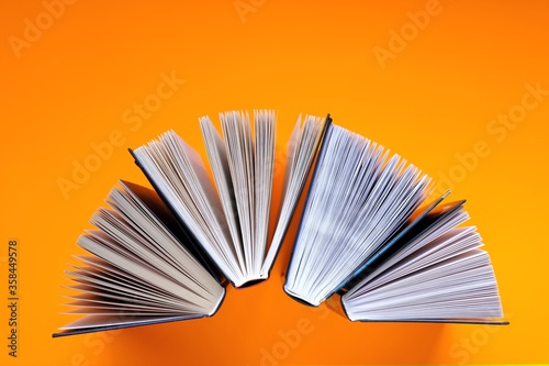 Books set on a bright orange background.Reading and education concept.books close up. Training and knowledge. top view, copy space.Books page close-up 