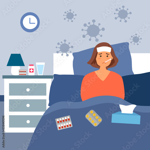Woman suffering from flu in bed under blanket. She has fever and take thermometer in mouth with tissue paper and medicine on bed.  Flu or cold allergy symptom.  Corona virus influenza infection.
