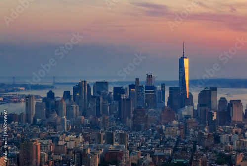New York Downtown and lower Manhattan skyline view with the One World Trade Center skyscraper at sunset