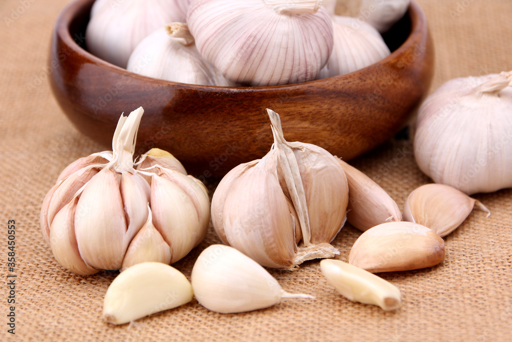 Garlic close-up on burlap background in studio. concept healthy lifestyle. Garlic close-up on burlap background in studio. concept healthy lifestyle.