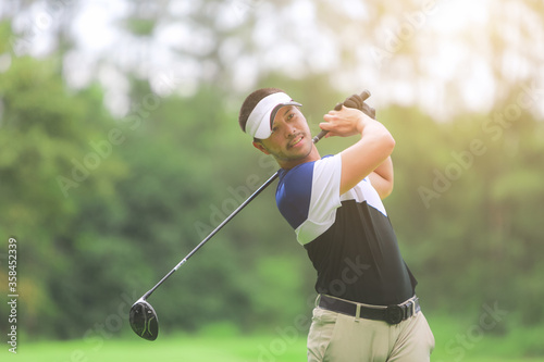 Golfer playing on beautiful golf green course.