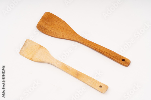 spade of frying pan made from wood on white background selective focus, kitchen flipper